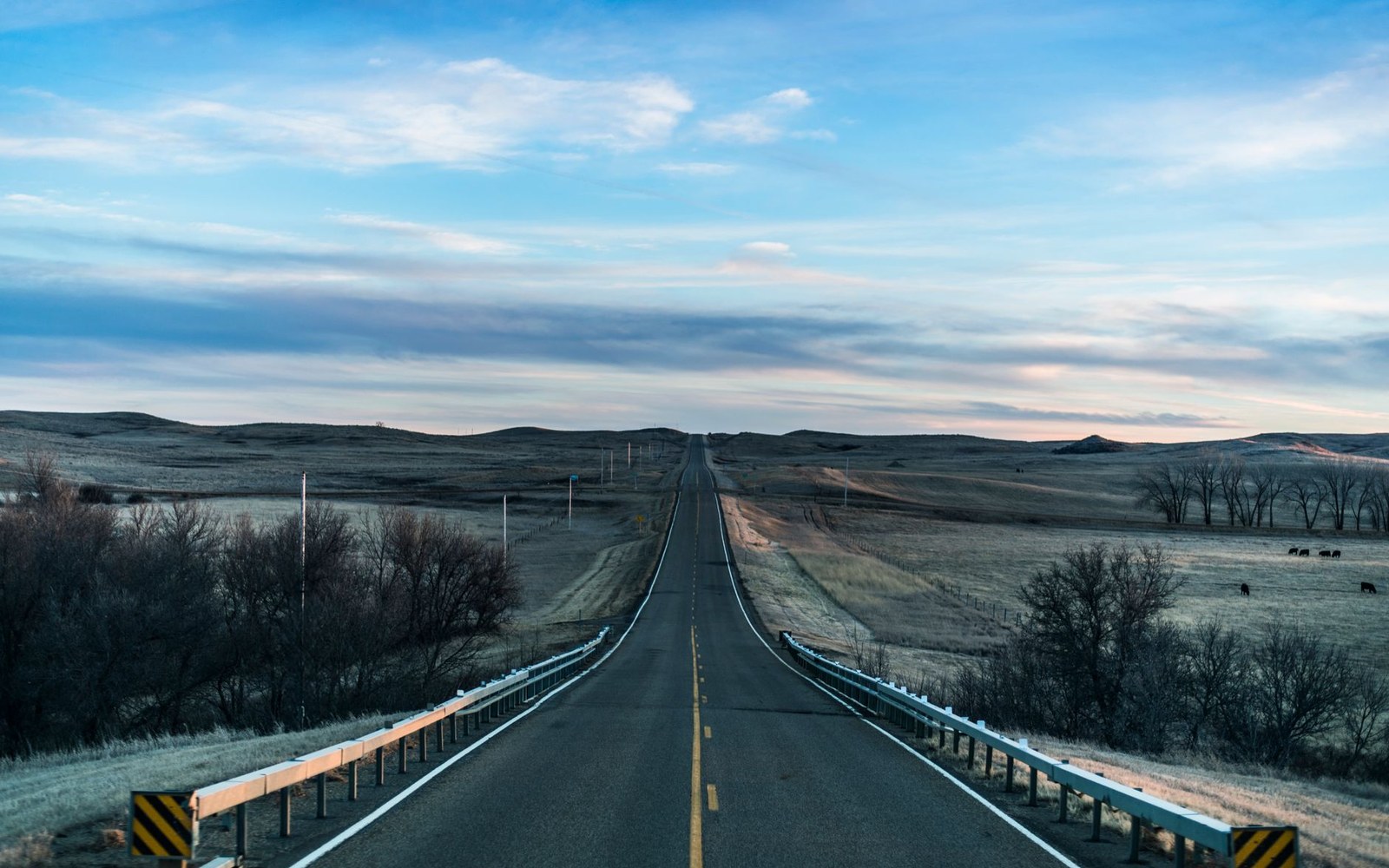 a two-lane road running dead straight to the horizon